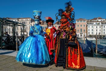 People in costume at the Venice carnival in front of the Madonna della Salute.