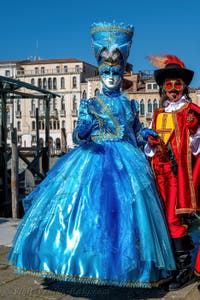 People in costume at the Venice carnival in front of the Madonna della Salute.