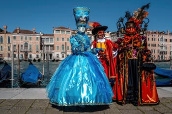 People in costume at the Venice carnival in front of the Madonna della Salute.