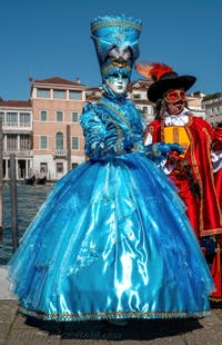 People in costume at the Venice carnival in front of the Madonna della Salute.