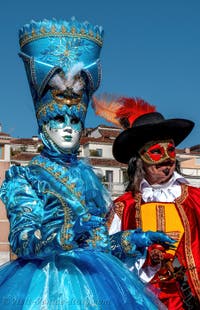 People in costume at the Venice carnival in front of the Madonna della Salute.