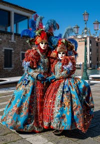 People in costume at the Venice carnival in front of the Madonna della Salute.