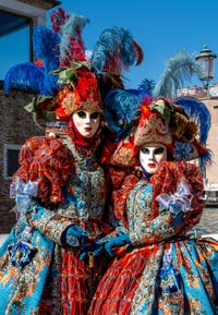 People in costume at the Venice carnival in front of the Madonna della Salute.