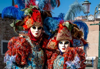 People in costume at the Venice carnival in front of the Madonna della Salute.