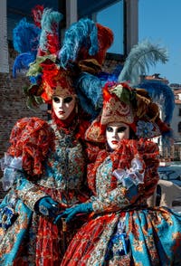 People in costume at the Venice carnival in front of the Madonna della Salute.