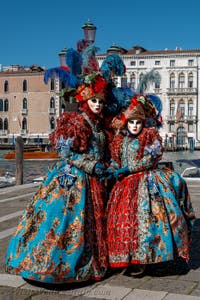 People in costume at the Venice carnival in front of the Madonna della Salute.