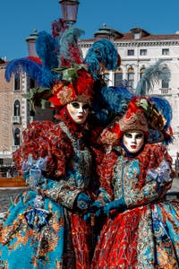 People in costume at the Venice carnival in front of the Madonna della Salute.