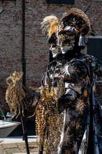 People in costume at the Venice carnival in front of the Madonna della Salute.