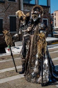 People in costume at the Venice carnival in front of the Madonna della Salute.