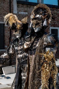 People in costume at the Venice carnival in front of the Madonna della Salute.