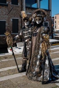 People in costume at the Venice carnival in front of the Madonna della Salute.