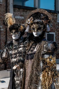 People in costume at the Venice carnival in front of the Madonna della Salute.