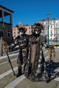 People in costume at the Venice carnival in front of the Madonna della Salute.