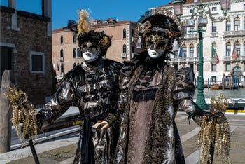 People in costume at the Venice carnival in front of the Madonna della Salute.