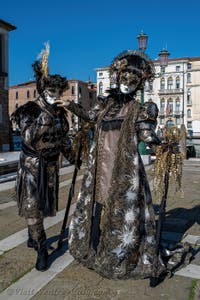 People in costume at the Venice carnival in front of the Madonna della Salute.