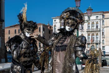 People in costume at the Venice carnival in front of the Madonna della Salute.