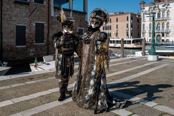 People in costume at the Venice carnival in front of the Madonna della Salute.