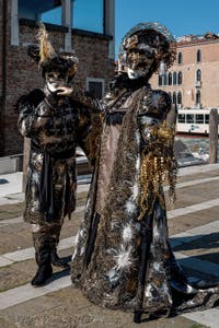 People in costume at the Venice carnival in front of the Madonna della Salute.