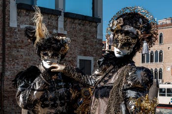 People in costume at the Venice carnival in front of the Madonna della Salute.