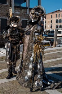 People in costume at the Venice carnival in front of the Madonna della Salute.