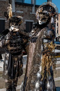 People in costume at the Venice carnival in front of the Madonna della Salute.