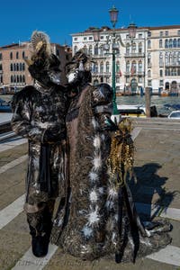 People in costume at the Venice carnival in front of the Madonna della Salute.