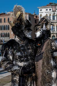 People in costume at the Venice carnival in front of the Madonna della Salute.