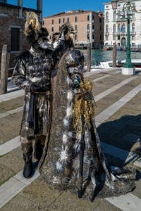 People in costume at the Venice carnival in front of the Madonna della Salute.