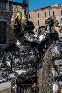 People in costume at the Venice carnival in front of the Madonna della Salute.