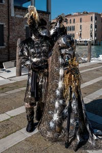 People in costume at the Venice carnival in front of the Madonna della Salute.