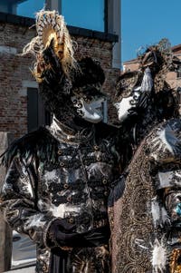 People in costume at the Venice carnival in front of the Madonna della Salute.