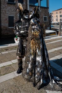 People in costume at the Venice carnival in front of the Madonna della Salute.