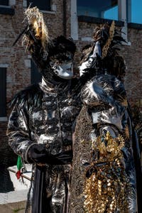 People in costume at the Venice carnival in front of the Madonna della Salute.