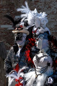 People in costume at the Venice carnival in front of the Madonna della Salute.