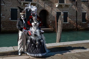 People in costume at the Venice carnival in front of the Madonna della Salute.