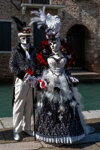 People in costume at the Venice carnival in front of the Madonna della Salute.