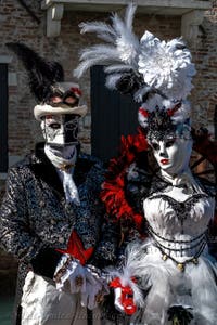 People in costume at the Venice carnival in front of the Madonna della Salute.