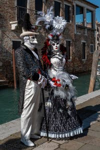 People in costume at the Venice carnival in front of the Madonna della Salute.