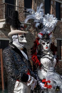 People in costume at the Venice carnival in front of the Madonna della Salute.