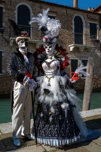 People in costume at the Venice carnival in front of the Madonna della Salute.