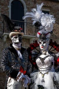 People in costume at the Venice carnival in front of the Madonna della Salute.