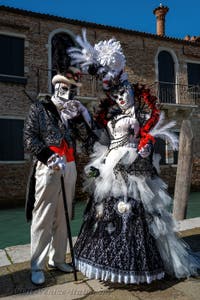 People in costume at the Venice carnival in front of the Madonna della Salute.