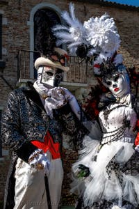 People in costume at the Venice carnival in front of the Madonna della Salute.