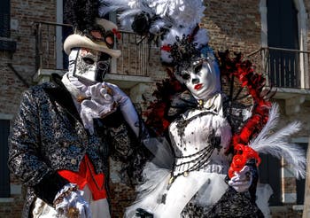 People in costume at the Venice carnival in front of the Madonna della Salute.