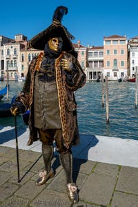 People in costume at the Venice carnival in front of the Madonna della Salute.