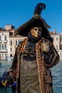 People in costume at the Venice carnival in front of the Madonna della Salute.