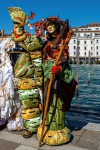 People in costume at the Venice carnival in front of the Madonna della Salute.