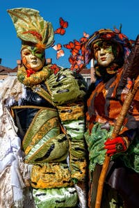 People in costume at the Venice carnival in front of the Madonna della Salute.