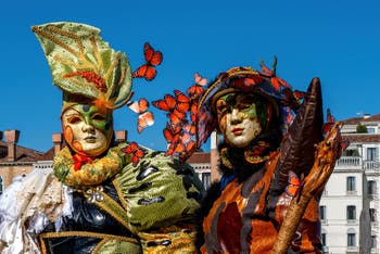 People in costume at the Venice carnival in front of the Madonna della Salute.