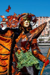 People in costume at the Venice carnival in front of the Madonna della Salute.